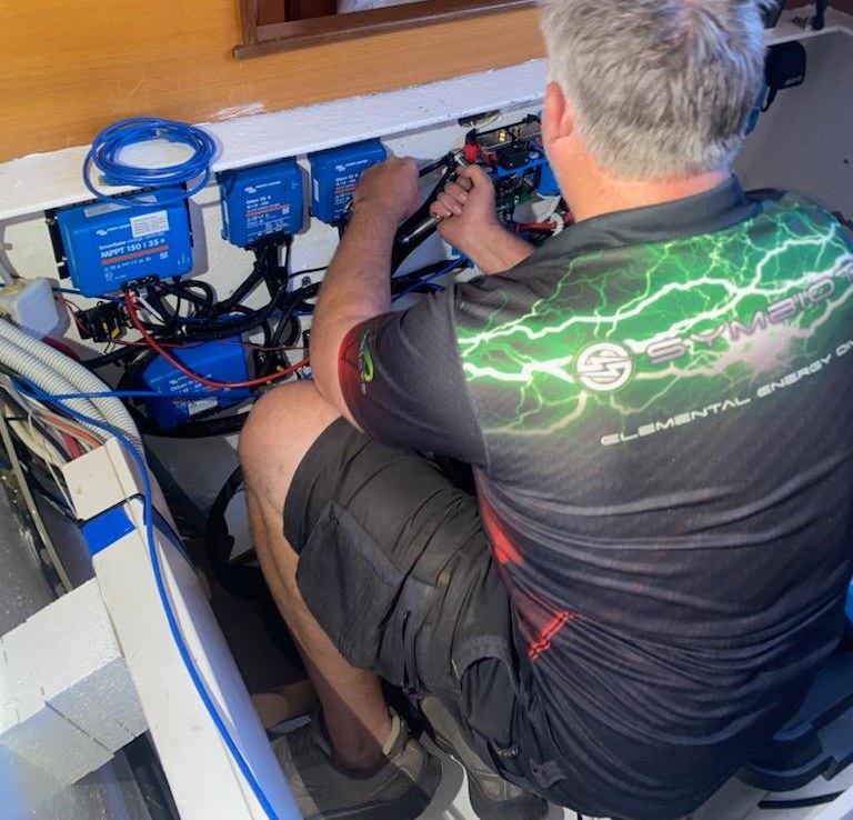 Rob James installing a Victron Energy system on a boat in Airlie Beach
